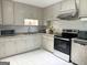 Functional kitchen featuring white cabinets, stainless steel appliances and easy-to-clean tile flooring at 6544 Bussell Way, Riverdale, GA 30274