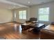 Comfortable living room boasts gleaming hardwood floors and an abundance of natural light at 6544 Bussell Way, Riverdale, GA 30274
