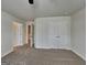 Carpeted bedroom with a large closet and two doorways, offering ample storage and easy access at 461 Best Friends Turn Aly, Mcdonough, GA 30252