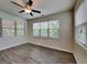 Bedroom bathed in natural light through ample windows, complemented by stylish ceiling fan at 461 Best Friends Turn Aly, Mcdonough, GA 30252