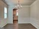 Elegant dining room featuring chandelier and decorative wall paneling at 461 Best Friends Turn Aly, Mcdonough, GA 30252