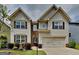 Charming two-story home with landscaped front yard and attached two-car garage at 461 Best Friends Turn Aly, Mcdonough, GA 30252