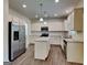 Modern kitchen with stainless steel appliances, granite countertops and central island at 461 Best Friends Turn Aly, Mcdonough, GA 30252