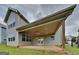 A covered patio with a ceiling fan and double doors is adjacent to the home at 461 Best Friends Turn Aly, Mcdonough, GA 30252