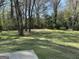 Picturesque backyard view with mature trees, a grassy lawn, and a serene, natural setting at 4063 Windsor Castle Way, Decatur, GA 30034