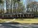 Charming single story red brick home with black shutters, white walkway, and covered front porch at 4063 Windsor Castle Way, Decatur, GA 30034