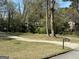 Expansive front yard with a winding driveway, mailbox, and lush greenery, creating a welcoming approach at 4063 Windsor Castle Way, Decatur, GA 30034