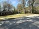 Street view of a red brick home, showcasing its spacious front yard and peaceful neighborhood setting at 4063 Windsor Castle Way, Decatur, GA 30034