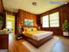 Virtual staging shows a bedroom with wood paneling and yellow accents at 4487 Berkshire Rd, Forest Park, GA 30297