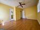 A yellow-painted bedroom features hardwood laminate flooring and a built-in cabinet at 4487 Berkshire Rd, Forest Park, GA 30297