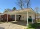 View of home's carport, screened in porch and back door with brick siding at 4487 Berkshire Rd, Forest Park, GA 30297