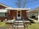 Inviting front door with a storm door, charming awning and decorative railing at 4487 Berkshire Rd, Forest Park, GA 30297
