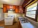 A well-lit kitchen featuring wood cabinets, laminate floors, and a double basin sink at 4487 Berkshire Rd, Forest Park, GA 30297