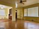 Living room featuring laminate floors and a built in cabinet at 4487 Berkshire Rd, Forest Park, GA 30297