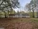 Back exterior showcasing a well-maintained yard and home with attached chimney at 260 Countryside Ln, Covington, GA 30016