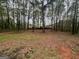 A spacious backyard offering a tree-lined perimeter with partial fencing at 260 Countryside Ln, Covington, GA 30016