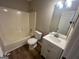 A bathroom featuring a shower-tub combo with a single sink vanity and modern light fixture at 260 Countryside Ln, Covington, GA 30016