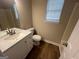 Bathroom featuring a white vanity and wood-look floors at 260 Countryside Ln, Covington, GA 30016