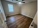 Bedroom features wood-look floors, a ceiling fan and natural light from the window at 260 Countryside Ln, Covington, GA 30016