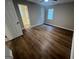 Bright bedroom with wood-look floors, window, and a ceiling fan at 260 Countryside Ln, Covington, GA 30016