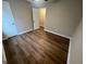 A bedroom featuring wood-look floors and a view of an open closet at 260 Countryside Ln, Covington, GA 30016
