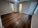 Bedroom features wood-look floors and views of the bathroom and closet at 260 Countryside Ln, Covington, GA 30016