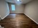 Neutral bedroom features wood-look floors, window, and ceiling fan at 260 Countryside Ln, Covington, GA 30016