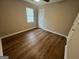 Bedroom features wood-look floors, a ceiling fan, and natural light at 260 Countryside Ln, Covington, GA 30016