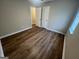 This bedroom offers neutral walls, a ceiling fan, and wood-look flooring throughout at 260 Countryside Ln, Covington, GA 30016