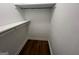 Walk-in closet with wood-look floors and white shelving at 260 Countryside Ln, Covington, GA 30016