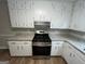 Modern kitchen showcasing granite countertops, ample white cabinetry, and gas range at 260 Countryside Ln, Covington, GA 30016