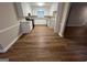 Open kitchen with granite countertops, white cabinets, and wood floors at 260 Countryside Ln, Covington, GA 30016