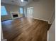Bright living room with hardwood floors, a white mantle fireplace, and ample natural light at 260 Countryside Ln, Covington, GA 30016