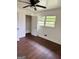 Comfortable bedroom features hardwood floors, a window view, and closet space at 1322 S Hicks Cir Nw, Conyers, GA 30012