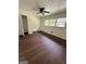 Relaxing bedroom featuring a ceiling fan, multiple windows and dark wood flooring at 1322 S Hicks Cir Nw, Conyers, GA 30012