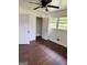 Bright bedroom features hardwood floors, a window view, and closet space at 1322 S Hicks Cir Nw, Conyers, GA 30012