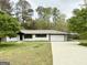 Charming single story home with brick exterior, attached garage, and concrete driveway and carport at 1322 S Hicks Cir Nw, Conyers, GA 30012