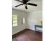 Inviting living room with dark wood flooring, and a view of the outdoors through the window at 1322 S Hicks Cir Nw, Conyers, GA 30012