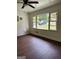 Bright living room featuring large window, wood flooring, and neutral wall color at 1322 S Hicks Cir Nw, Conyers, GA 30012
