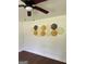 Stylish wall decor enhances the room's aesthetic, complemented by a ceiling fan and warm lighting at 1322 S Hicks Cir Nw, Conyers, GA 30012