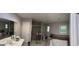 Full bathroom featuring dual sinks, a soaking tub, walk-in shower, and windows for natural light at 2387 Shire Ct, Austell, GA 30106