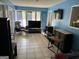 Bright living room with blue walls, large windows, and a flat-screen TV, perfect for relaxation at 2387 Shire Ct, Austell, GA 30106