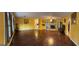 Bright living room features hardwood floors, yellow walls, a brick fireplace, and an open layout at 2387 Shire Ct, Austell, GA 30106