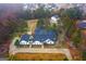 Stunning aerial view of a white brick home with mature trees and a driveway at 2615 Hampton Locust Grove Rd, Locust Grove, GA 30248