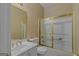 Bright bathroom features a vanity with sink, toilet, and a shower/tub with sliding glass doors at 2615 Hampton Locust Grove Rd, Locust Grove, GA 30248