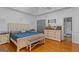 Bright bedroom with hardwood floors features a decorative bedframe and furniture set at 2615 Hampton Locust Grove Rd, Locust Grove, GA 30248