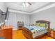 Bedroom featuring hardwood floors, tray ceiling, and traditional furnishings at 2615 Hampton Locust Grove Rd, Locust Grove, GA 30248