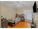 Well-lit bedroom includes a bed, dresser, and hardwood floors at 2615 Hampton Locust Grove Rd, Locust Grove, GA 30248