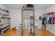 Walk-in closet with shelving, drawers, hanging racks, and a full-length mirror at 2615 Hampton Locust Grove Rd, Locust Grove, GA 30248