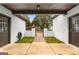 Enclosed courtyard with brick walls, iron gate, and dual access doors at 2615 Hampton Locust Grove Rd, Locust Grove, GA 30248